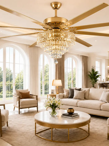 72 inch Queen crystal gold ceiling fan with multiple wooden blades hangs in a bright, modern living room with a crystal chandelier, beige sofa, and large arched windows.