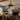 Farmhouse style ceiling fan light in a rustic living room with fireplace and wood accents