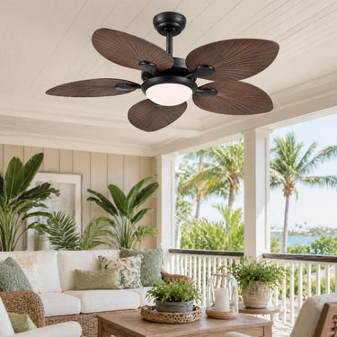 Luxury coastal resort style living room with a large tropical ceiling fan overlooking the ocean view.