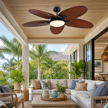 Luxury outdoor patio setup featuring the 62 inch waterproof palm leaf ceiling fan spinning above a comfortable outdoor sectional sofa.