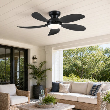 Black 42 inch flush mount ceiling fan with light installed in a outdoor patio