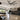 Kviflon 9001 giant 100 inch industrial ceiling fan running in a spacious high-ceiling commercial warehouse bay.